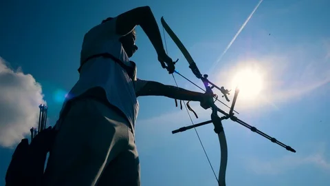 Sunlit sky and an archer in the process of aiming Video stock 113454018