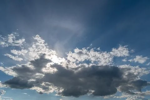Sunlit sky with dramatic cloud formations and sun rays Stock Photos