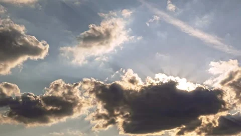 Sunlit Sky with Fluffy Clouds and Bright Sunbeams Shining Through 库存影片 313405999