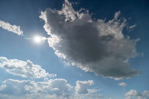 Sunlit sky with large cumulus cloud and scattered clouds Photos