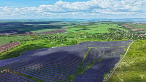 Sunlit solar arrays. Drone capturing vast photovoltaic field scenery. Elevated Video stock 339530709