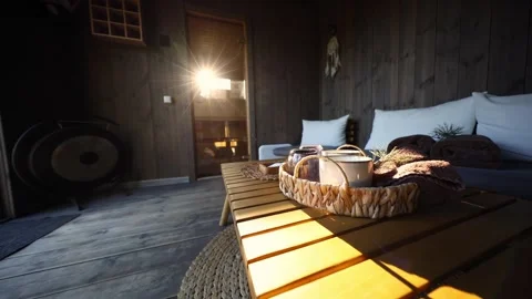 Sunlit spa cabin interior with gong, dreamcatcher, and pine accents Stock Footage 337264675