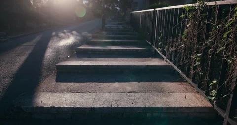 Sunlit stone steps beside road in Sibenik Croatia Stock Footage 336140944