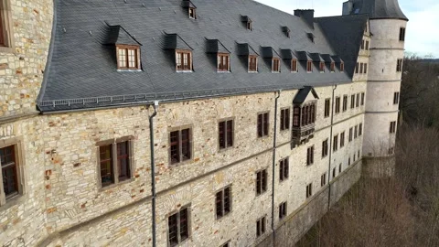 Sunlit stone wall rising to the castle roofline Stock Footage 331209734