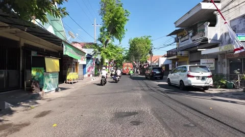 Sunlit street lined with trees and shops Stock Footage 345151390