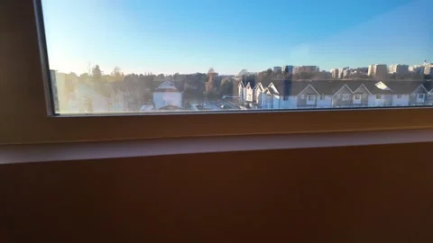 Sunlit Suburban View Through the Window at Dusk Stock Footage 257868765