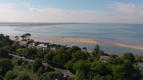 Sunlit Sutton Seafront Villas Overlooking Sand Spit and Calm Bay Stock Footage 338067472