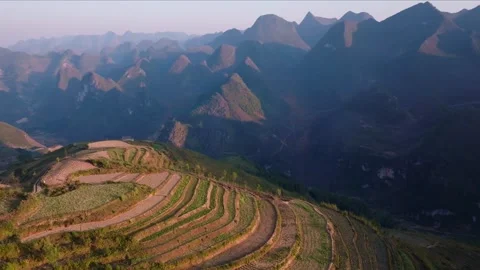 Sunlit Terraced Rice Fields and Majestic Mountains in Ha Giang Stock Footage 280233566