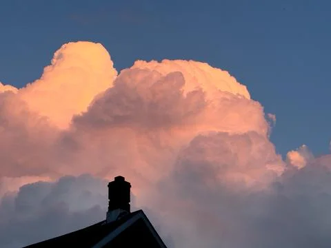 A sunlit thundercloud at sunset Stock Photos