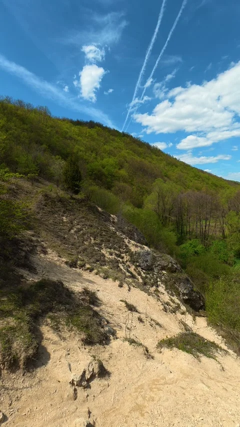 Sunlit trail winds through green hills. Vertical POV, Balkan, Eastern Europe Stock-Footage 333700015