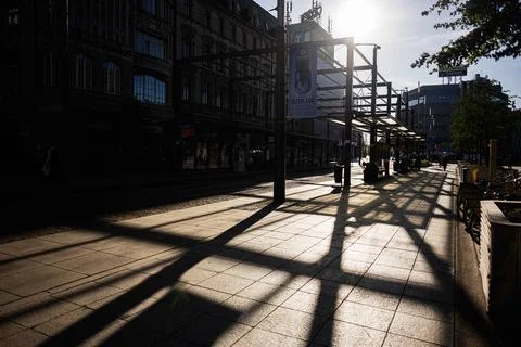 Sunlit tram platform and strong shadow patterns at a Katowice, Poland city .. Stock Photos