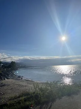 Sunlit Tranquility by the Sea Stock Photos