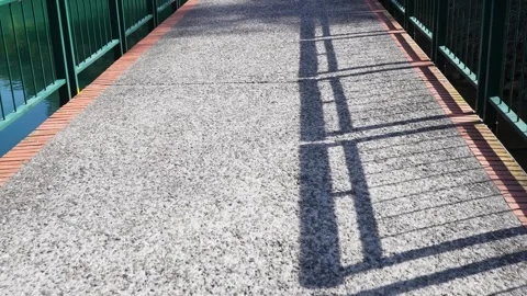 Sunlit Urban Bridge with Cast Shadow Railings Stock Footage 268908803
