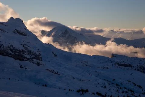 Sunlit valley and clouds under Mont Blanc Stock Photos