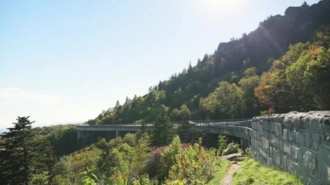 Sunlit Viaduct On Mountain Ridge Stone Guardrail Winding Path Mixed Deciduous Stock Footage 325825285