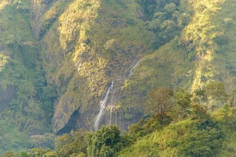 Sunlit Waterfall Trickling Down Steep Mountain Slopes in Kerala Stock Photos