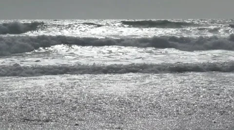 Sunlit waves on the beach Stock Footage 49640289