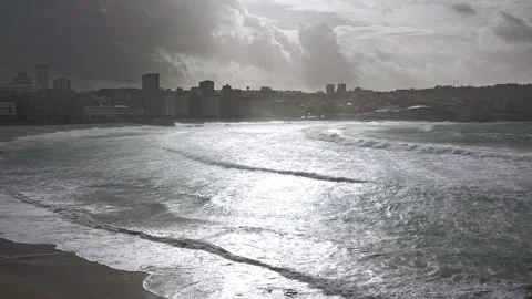Sunlit Waves: The Majesty of the Ocean Meets the City Stock Footage 263837907