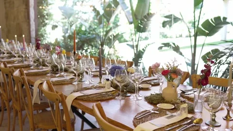 Sunlit wedding table dressed in rustic elegance with floral and candle details Stock Footage 310177249