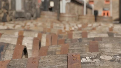 Sunlit Whiskey Casks Lined Up for Aging Process Outside of a Distillery 스톡 동영상 97615922