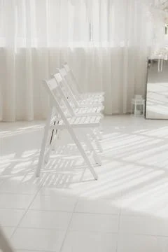Sunlit White Folding Chairs Lined In Minimalist Studio With Sheer Curtains, Фото
