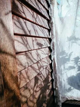 Sunlit window with shadow play Stock Photos