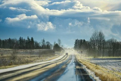 Sunlit Winter Road Through Open Countryside Stock Photos