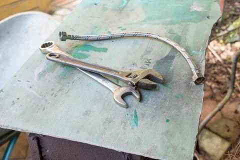 Sunlit workshop table with scattered tools in repose. Stock Photos