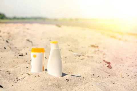 Sunlotion in the sand on a beach Stock Photos