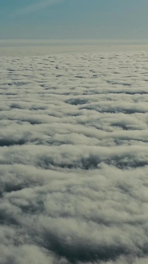 Sunny Airplane Window View Above White Clouds With Clear Blue Sky During Stock Footage 338045434