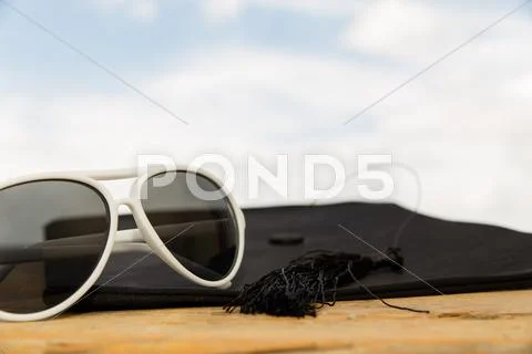 Sunny background with mortarboard Stock Photos