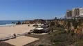 Sunny beach cliffs and city buildings with blue sky in Portimao Portugal 4k or 4k+ Resolution
