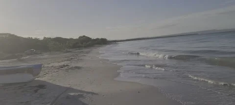 Sunny beach with distant rain shower over the ocean horizon  스톡 동영상 329072525