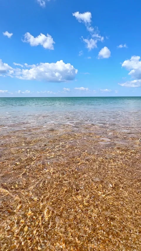 Sunny beach with a turquoise ocean in background. Sea waves near tropical coast Stock Footage 305872206