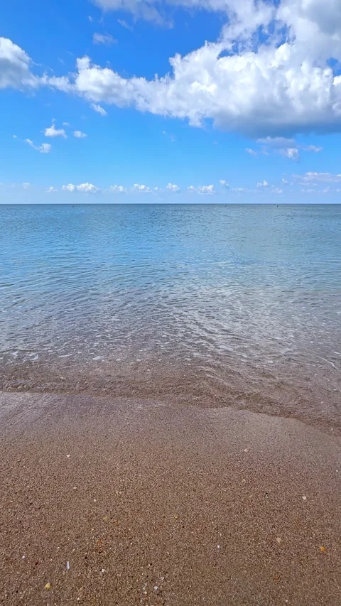 Sunny beach with a turquoise ocean in background. Sea waves near tropical coast Stock Footage 305872853