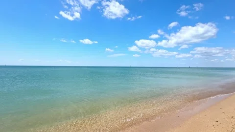 Sunny beach with a turquoise ocean in background. Sea waves near tropical coast Stock Footage 305873150