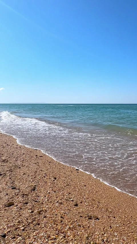 Sunny beach with a turquoise ocean in background. Sea waves near tropical coast Stock Footage 305873408