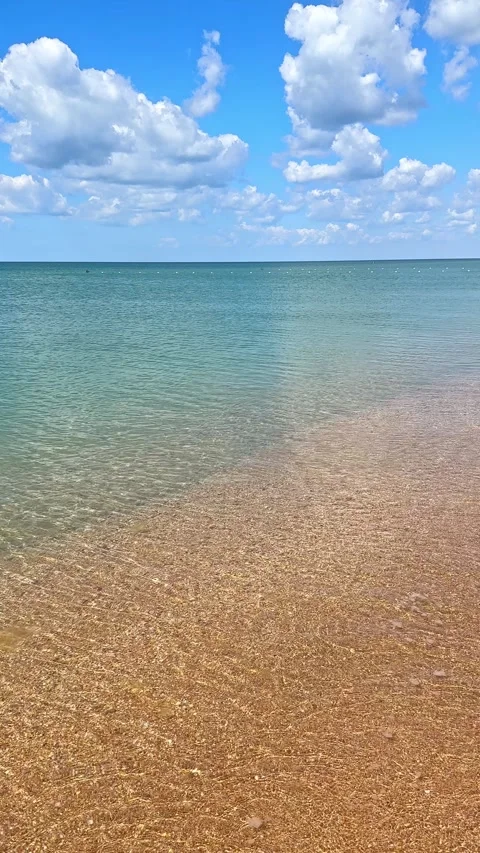 Sunny beach with a turquoise ocean in background. Sea waves near tropical coast Stock Footage 305875713