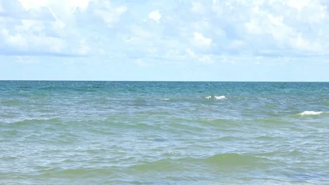 Sunny beach with a turquoise ocean in background. Sea waves near tropical coast Stock Footage 312815456