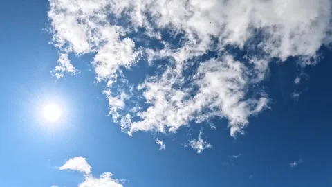 Sunny blue sky with changing cloud shapes in wide open view Stock Footage 316975516