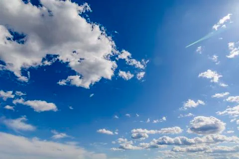 Sunny blue sky with clouds  in spring time . Stock Photos