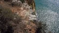 Sunny cliffs nature landscape tilt up at Algarve coastline Portugal 4k or 4k+ Resolution