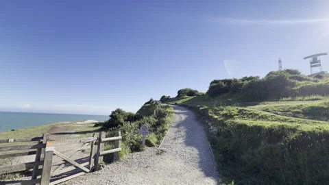 Sunny cliffside walking path gate detail Stock Footage 336514846