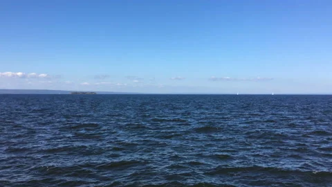 Sunny cloudless day. Waves splashing on a large river. Beautiful view. Horizon. Stock Footage 115794473