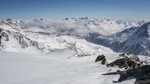 Sunny Day Above Clouds in Winter Snowy Alps Mountains. Time Lapse Dolly Shot Stock Footage 71348032