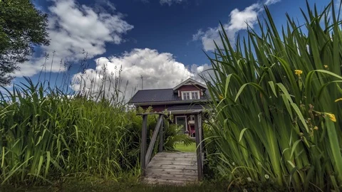 Sunny day many clouds fly over swedish red house before rain time timelapse Stock Footage 89976306