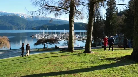 Sunny day, park, lake, mountains, sunny day, people walking Stock Footage 58681353