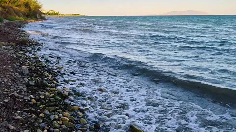 Sunny Day at Pebble Beach with a View of Marmara Island Stock Footage 322946366