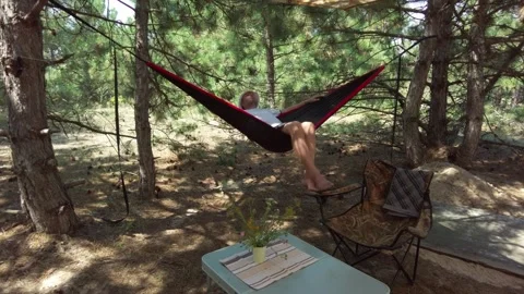 Sunny Day in Pine Forest: Man Enjoying Hammock Swing During Vacation Stock-Footage 288318281