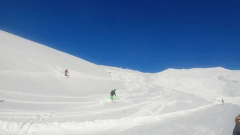 Sunny Day Off-Piste Skiing: Multiple Skiers Carving Fresh Tracks in Powder Stock Footage 265249879